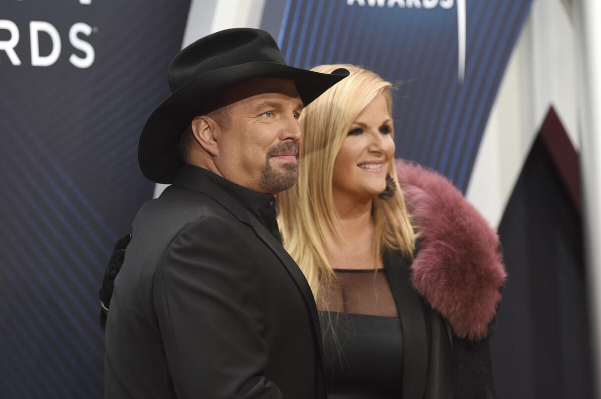 Garth Brooks and Trisha Yearwood arrive at the 52nd CMA Awards.