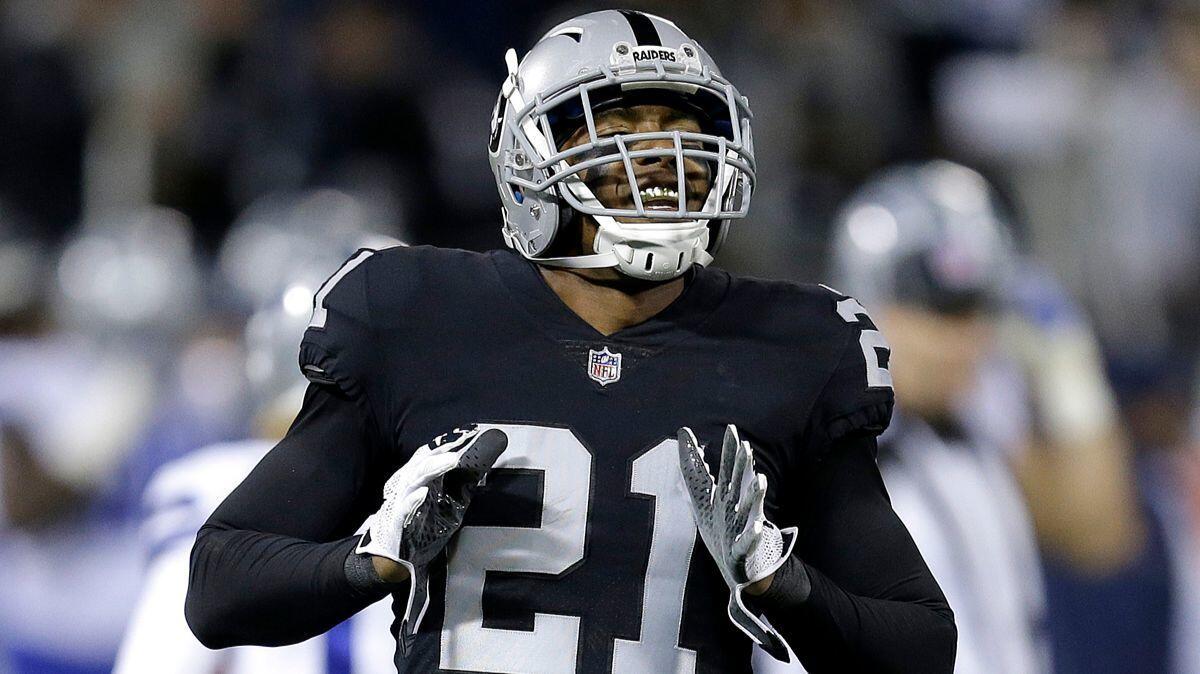 Oakland Raiders cornerback Sean Smith reacts after intercepting a pass against the Dallas Cowboys during the first half on Sunday.