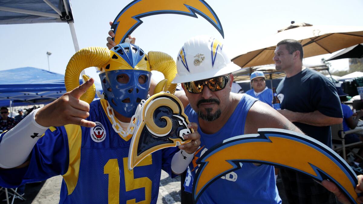 Playing in different conferences, the Rams and Chargers might not see too much of each other in the regular season. So fans Paul Castaneda, left, and Bryan Bahr used last month's exhibition to show their true colors.