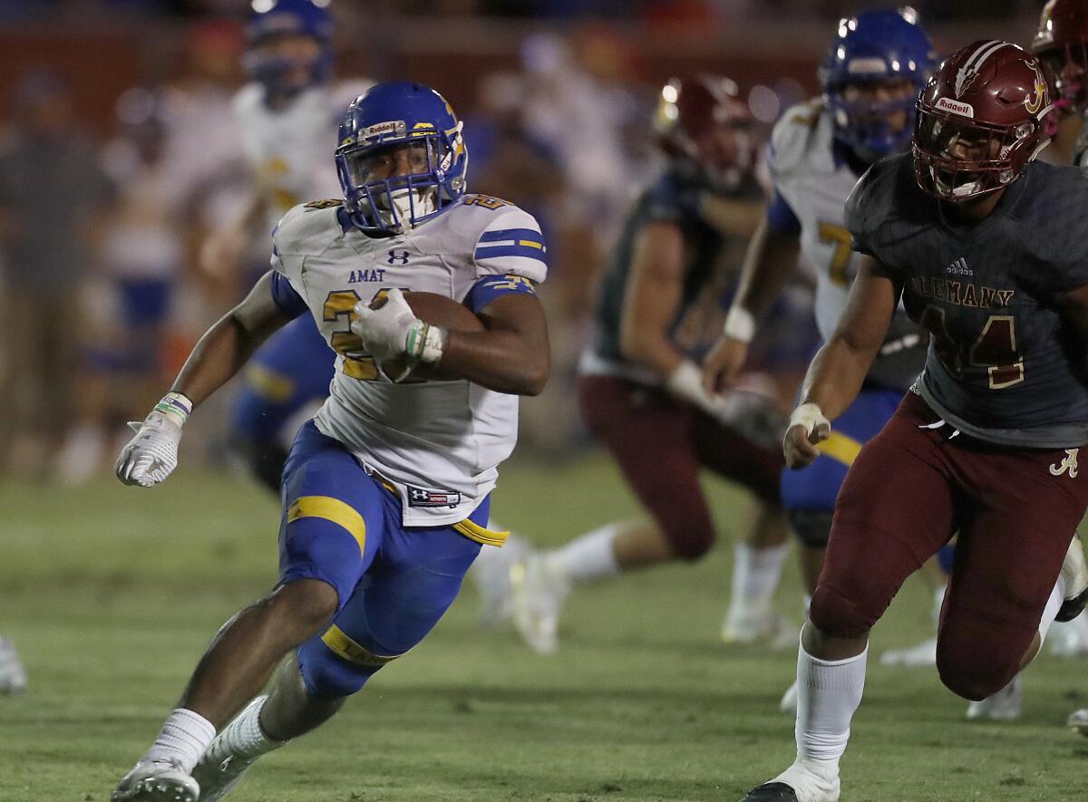 Bishop Amat running back Damien Moore scores a touchdown against Alemany in the third quarter.