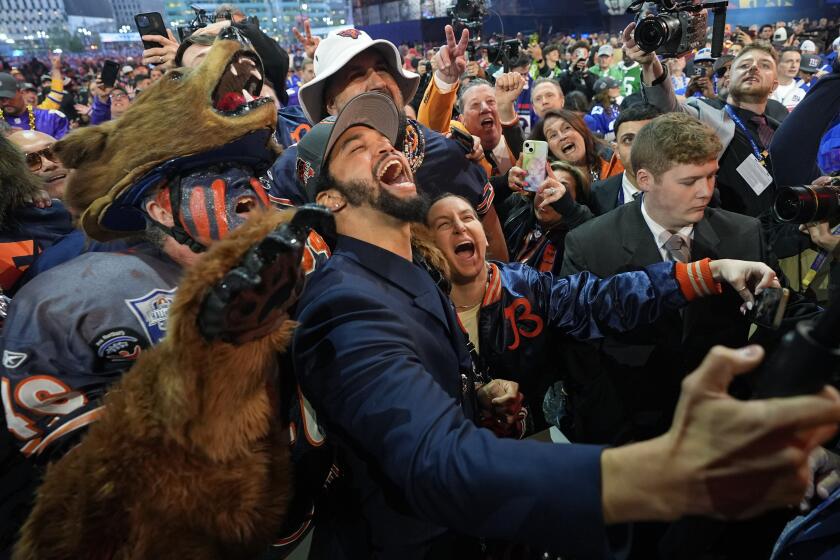 Southern California quarterback Caleb Williams celebrates after being chosen by the Chicago Bears.