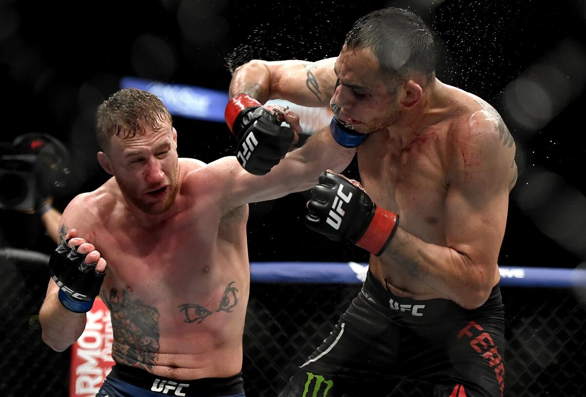 Justin Gaethje, left, hits Tony Ferguson at UFC 249 on May 9, 2020, in Jacksonville, Fla.