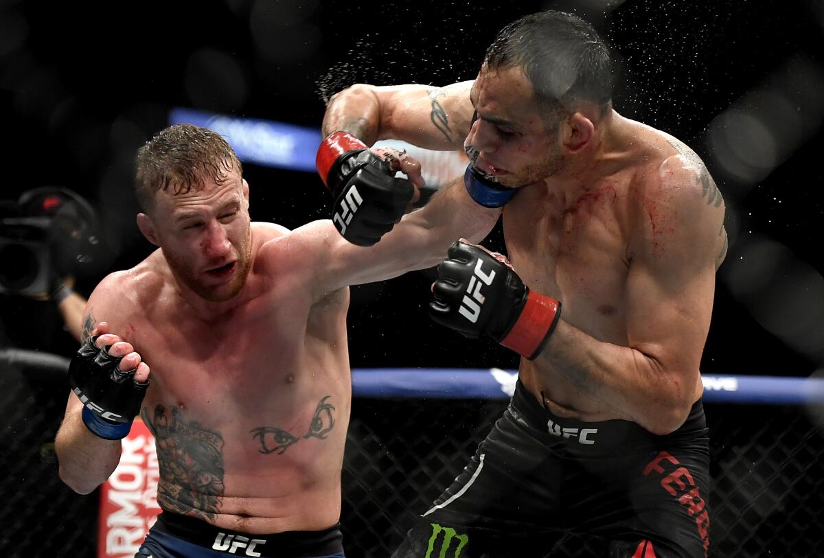 Justin Gaethje, left, hits Tony Ferguson at UFC 249 on May 9, 2020, in Jacksonville, Fla. 