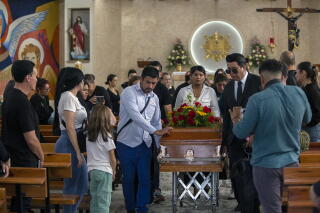 Relatives pull the coffin of Mexican journalist Mauricio Cruz Solis during his wake