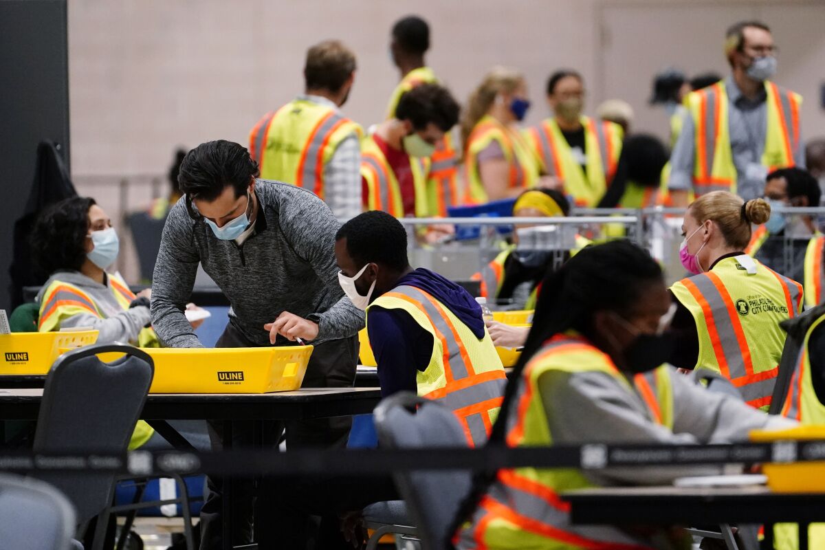Philadelphia election workers process mail-in and absentee ballots at the Pennsylvania Convention Center.