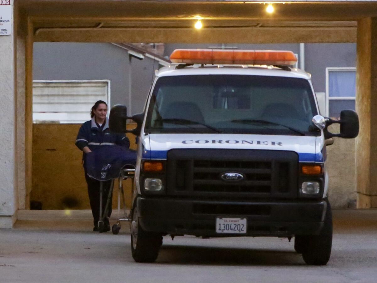 A worker from the Los Angeles County coroner's office retrieves the body of a male juvenile fatally shot in Duarte on Monday night. Family members identified the victim as 16-year-old Cristopher Rossi.
