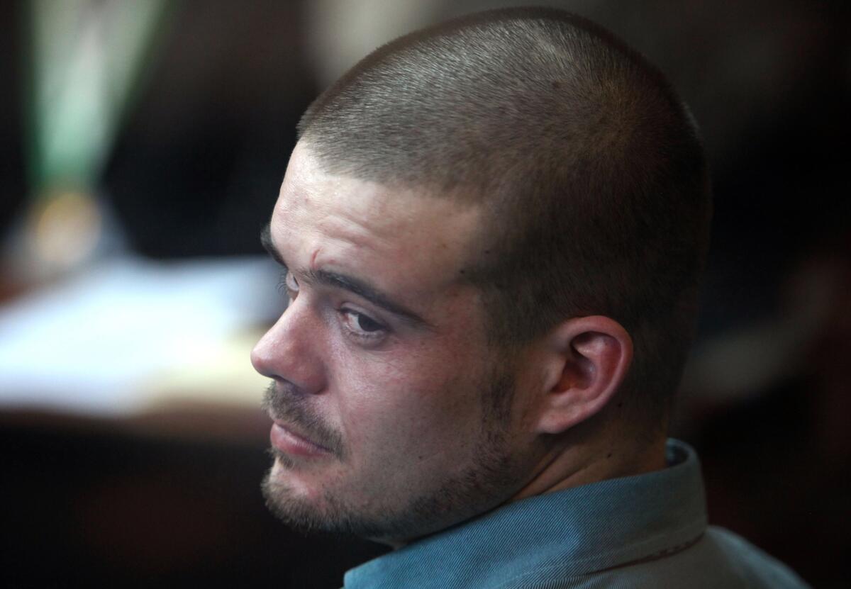 Joran van der Sloot turns his head in a courtroom.