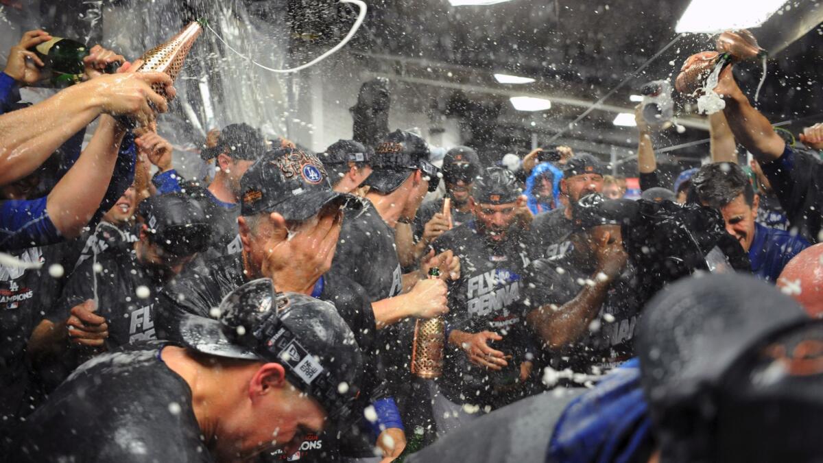 The Dodgers celebrate after defeating the Cubs in Game 5 of the National League Championship Series on Thursday at Wrigley Field.