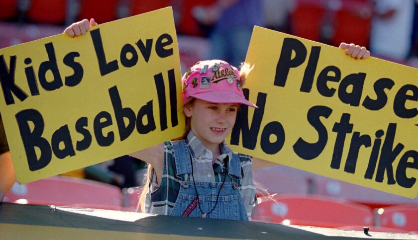Erin States, 10, of Tracy, Calif., holds up a sign at an Oakland A's game on Aug. 11, 1994, urging major leaguers not to strike.