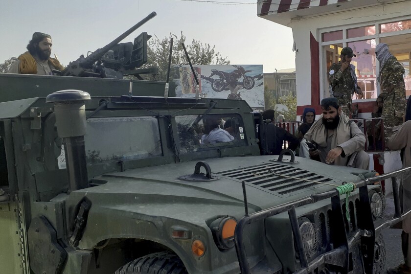 Taliban fighters stand guard in Kunduz city, northern Afghanistan