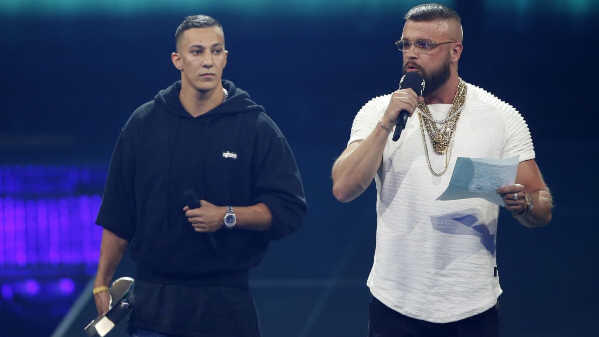 German rappers Kollegah and Farid Bang receive the Hip-Hop/Urban National award during the 2018 Echo Music Awards ceremony in Berlin on Thursday.
