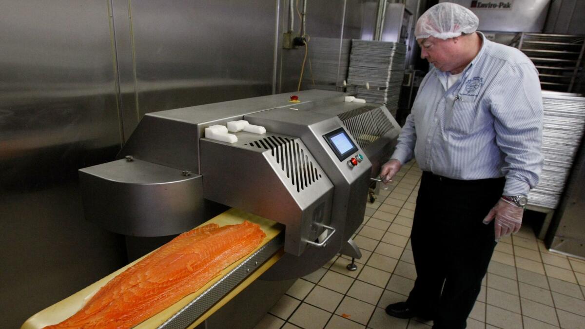 Michel Blanchet with a salmon slicer at Michel Cordon Bleu in March 2010.