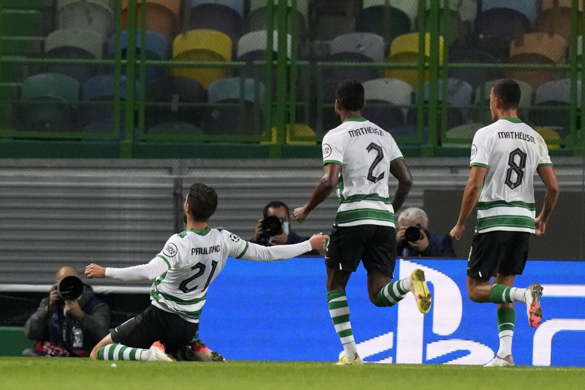 Sporting's Paulinho, left, celebrates after scoring his side's third goal during the Champions League Group C soccer match between Sporting CP and Besiktas at the Alvalade stadium in Lisbon, Portugal, Wednesday, Nov. 3, 2021. (AP Photo/Armando Franca)