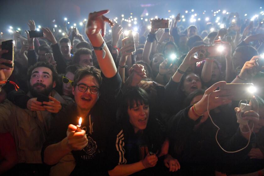 Spectators cheer during a concert at the 39th edition of the Trans Musicales music festival in Saint-Jacques-de-la-Lande, outside Rennes, northwestern France, on December 7, 2017. The 39th edition of the Trans Musicales music festival takes place until December 10. / AFP PHOTO / LOIC VENANCE (Photo credit should read LOIC VENANCE/AFP via Getty Images)