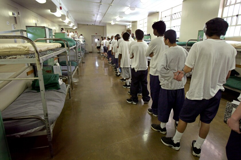 Juvenile inmates stand in line.