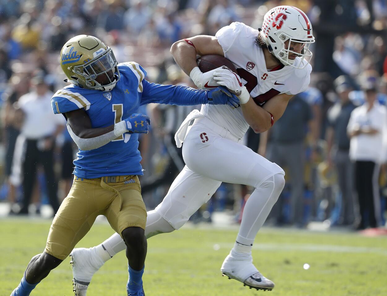 Stanford tight end Colby Parkinson brings a pass reception to the UCLA two-yard line against Bruins cortnerback Darnay Holmes in the second quarter.