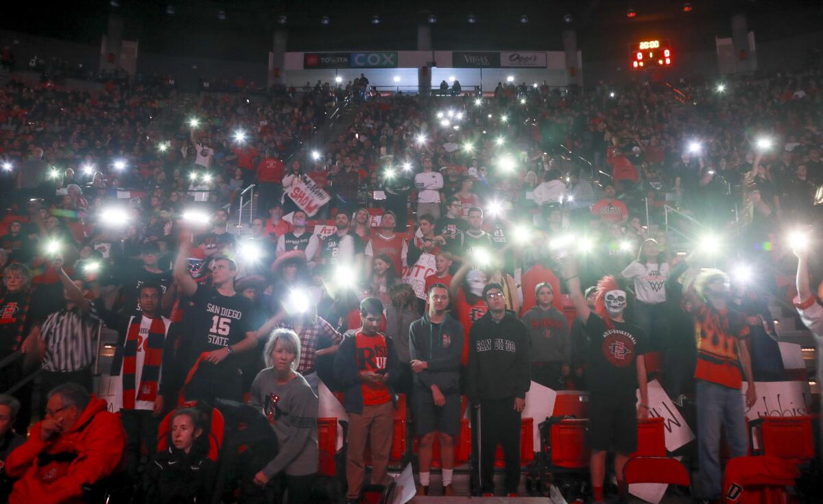 Fans light up their phones before an SDSU game at Viejas Arena. Season ticket prices increased for next season.