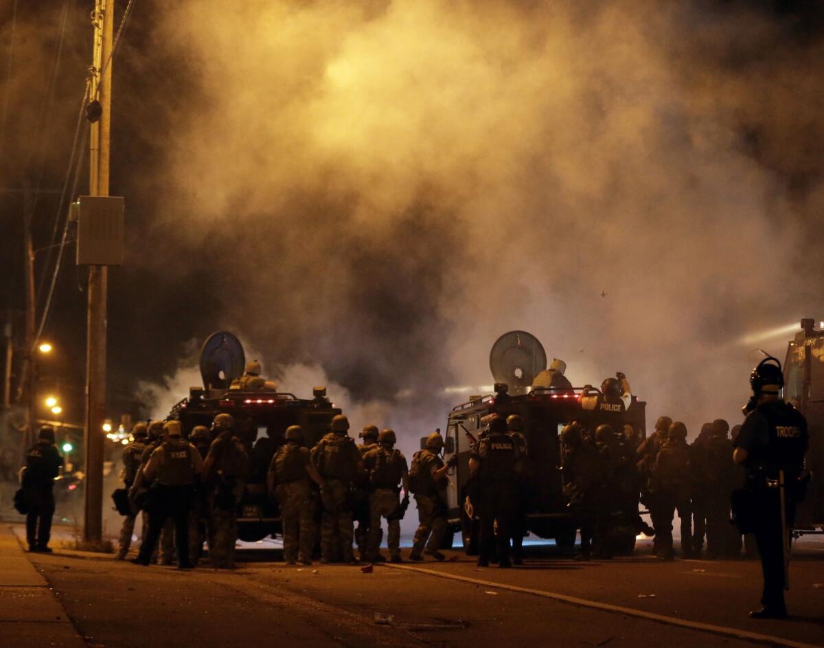 Police on the streets of Ferguson, Mo., on Sunday night.