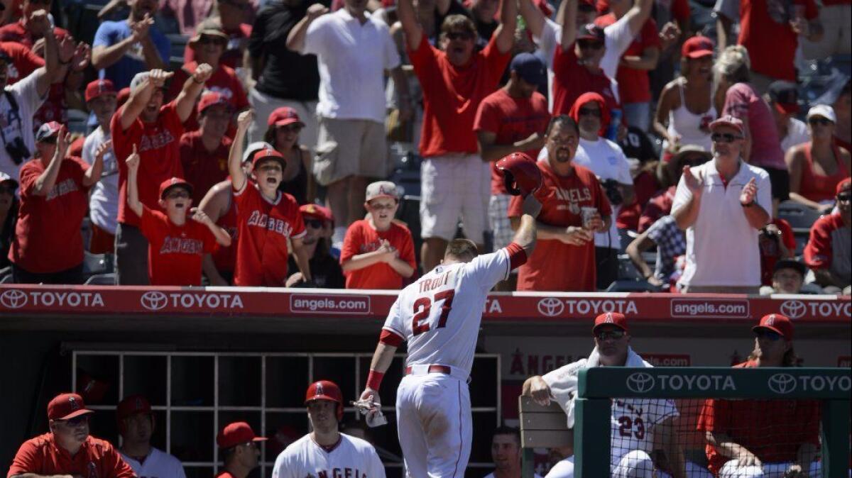Angels outfielder Mike Trout acknowledges the fans after hitting a grand slam during a game against the Texas Rangers on July 26.