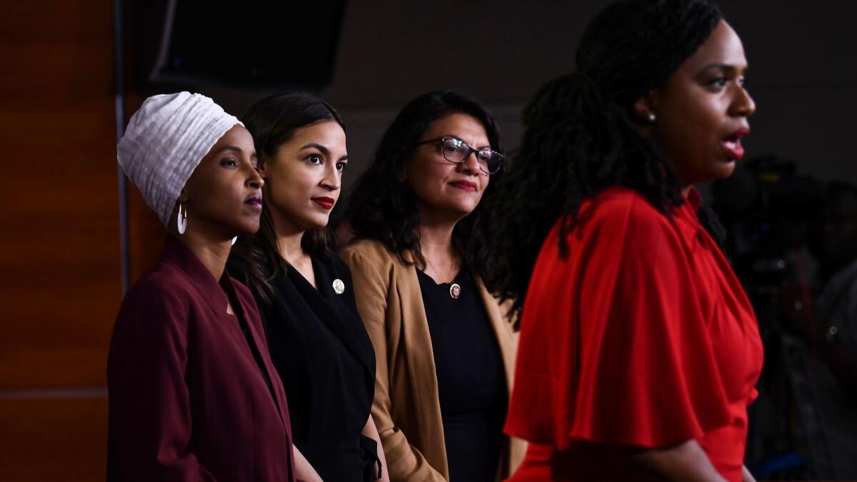 Rep. Ayanna Pressley (D-Mass.) speaks to reporters as Reps. Ilhan Omar (D-Minn.), from left, Alexandria Ocasio-Cortez (D-N.Y.) and Rashida Tlaib (D-Mich.) look on.