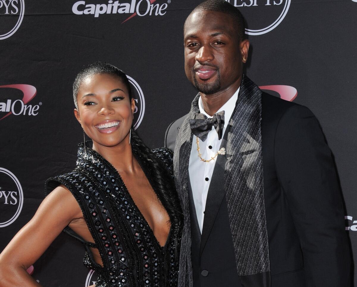 Basketball star Dwyane Wade, right, has reportedly fathered his third child, but the mother is not his new fiancee Gabrielle Union, reports say.