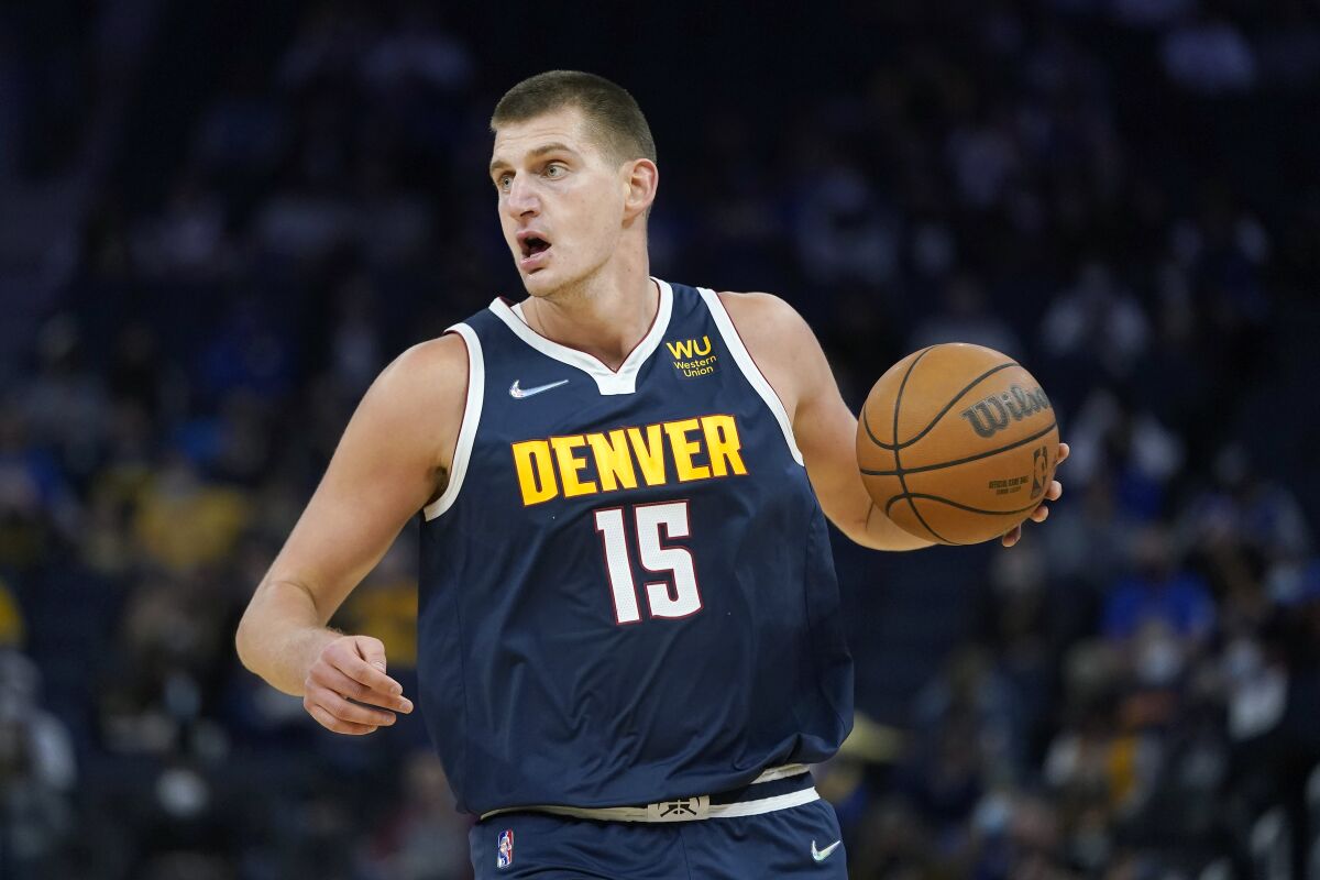 Denver Nuggets center Nikola Jokic dribbles aduring the first half of the team's preseason NBA basketball game against the Golden State Warriors in San Francisco, Wednesday, Oct. 6, 2021. (AP Photo/Jeff Chiu)