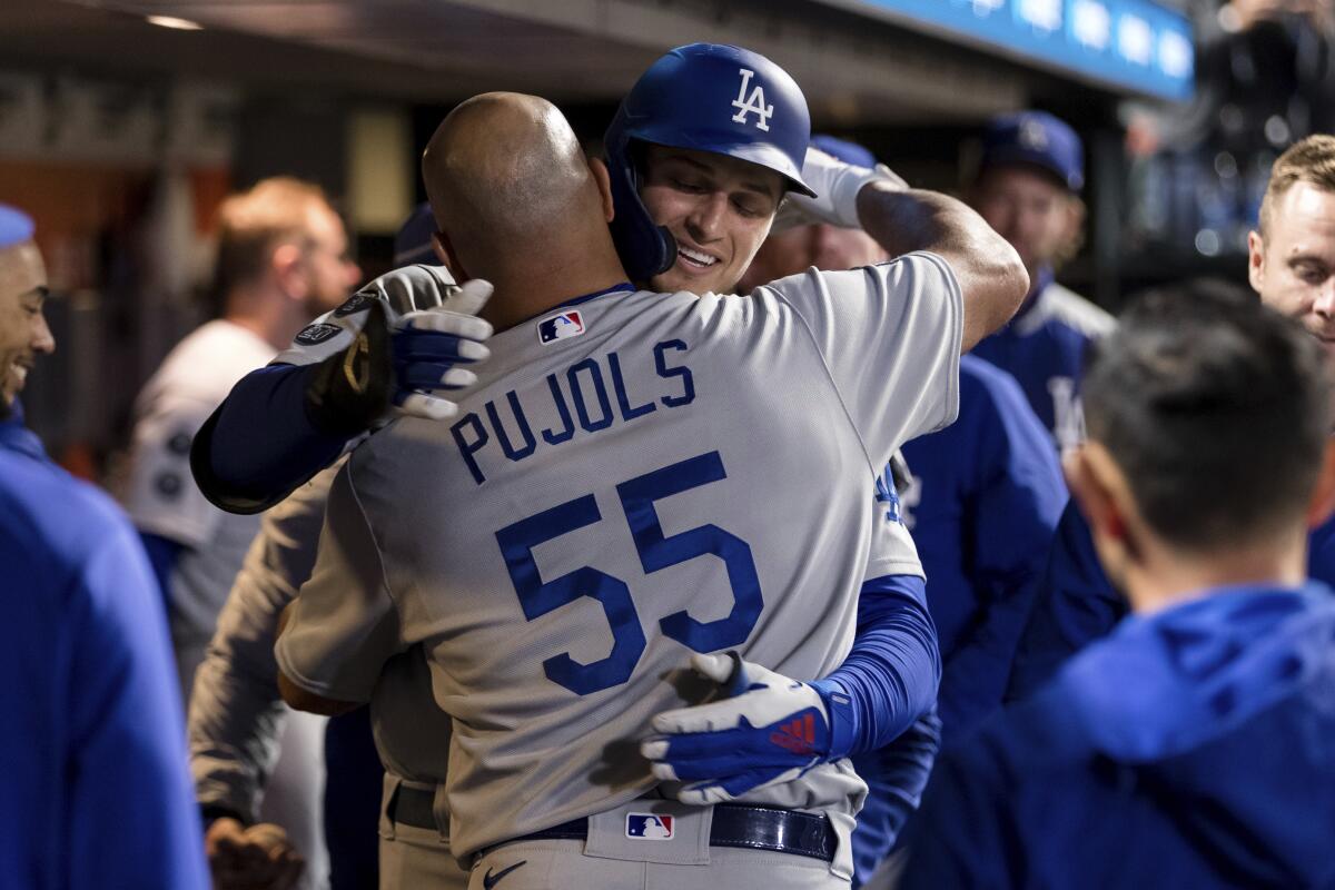 Los Angeles, United States. 8th Aug, 2021. Los Angeles Dodgers' first  baseman Albert Pujols (55) is hugged by teammate Max Muncy after hitting a  two-run homer off Los Angeles Angels' starting pitcher