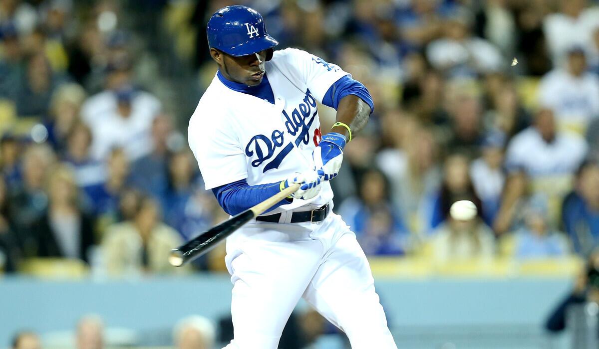 Dodgers right fielder Yasiel Puig connects for a run-scoring single in the third inning against the Rockies on Friday night at Dodger Stadium.