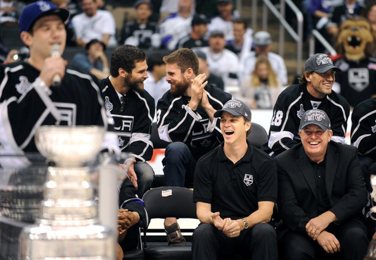 Then-AEG Chief Executive Tim Leiweke, right, and Kings President Luc Robitaille laugh during a speech by goalie Jonathan Quick during a Stanley Cup championship rally at the Staples Center last spring.