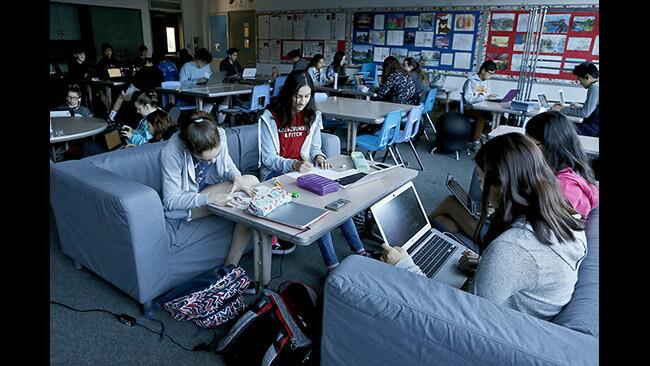 La CaÃ±ada High School eighth grade history class students Kyra Aitelli, left, Sanika Vaze, second from left, Audrey Kim, second from right and Kiani Baetsle, right, work on their class projects while sitting on sofas in their classroom on Thursday, Feb. 8, 2018. Teacher Joanne Park-Smith is trying out a new â€œFlexible Seatingâ€ arrangement made possible by an innovation grant from the La CaÃ±ada Flintridge Educational Foundation.