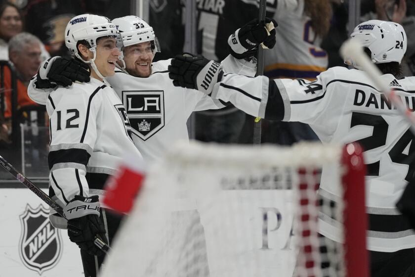 Kings left wing Trevor Moore celebrates with right wing Viktor Arvidsson (33) and center Phillip Danault (24) after scoring