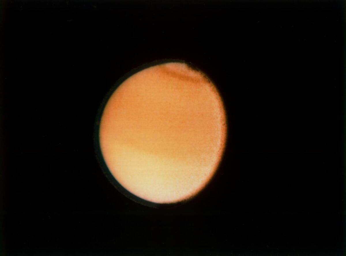 This Voyager 2 photograph of Titan, taken Aug. 23, 1981, from a range of 1.4 million miles, shows some detail in the cloud systems on this Saturnian moon.