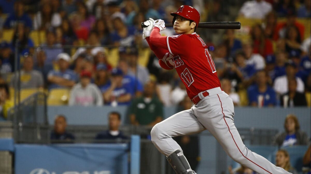 Angels pinch hitter Shohei Ohtani tracks his hit as he starts to run for first base against the Dodgers at Dodger Stadium on Friday.