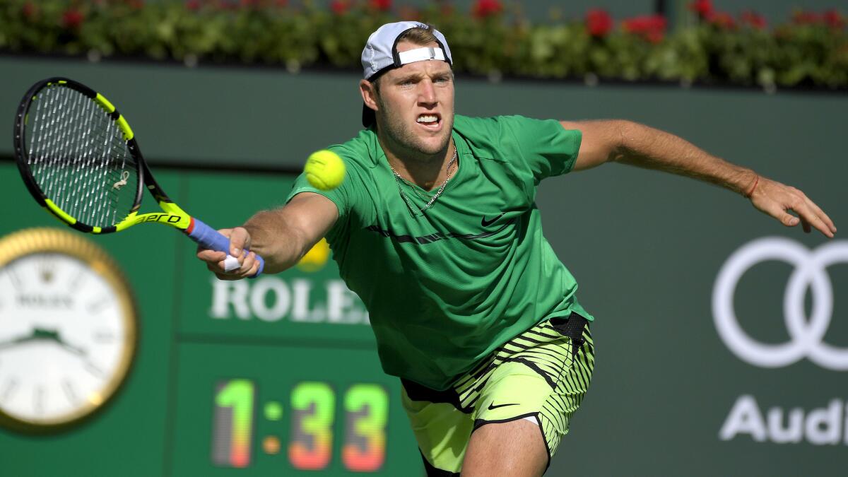 Jack Sock reaches to return a shot against Kei Nishikori during their quarterfinal match at the BNP Paribas Open on Friday.