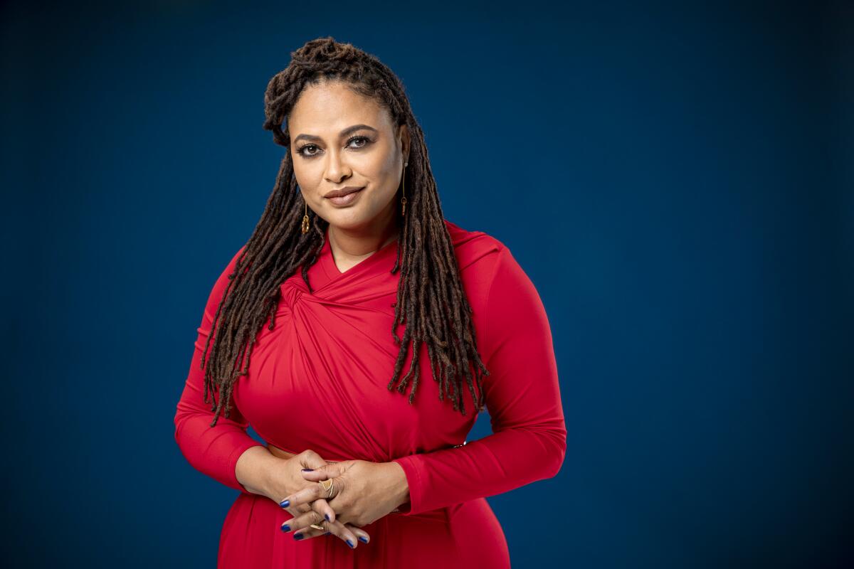 Writer-director Ava DuVernay poses for a portrait against a blue background