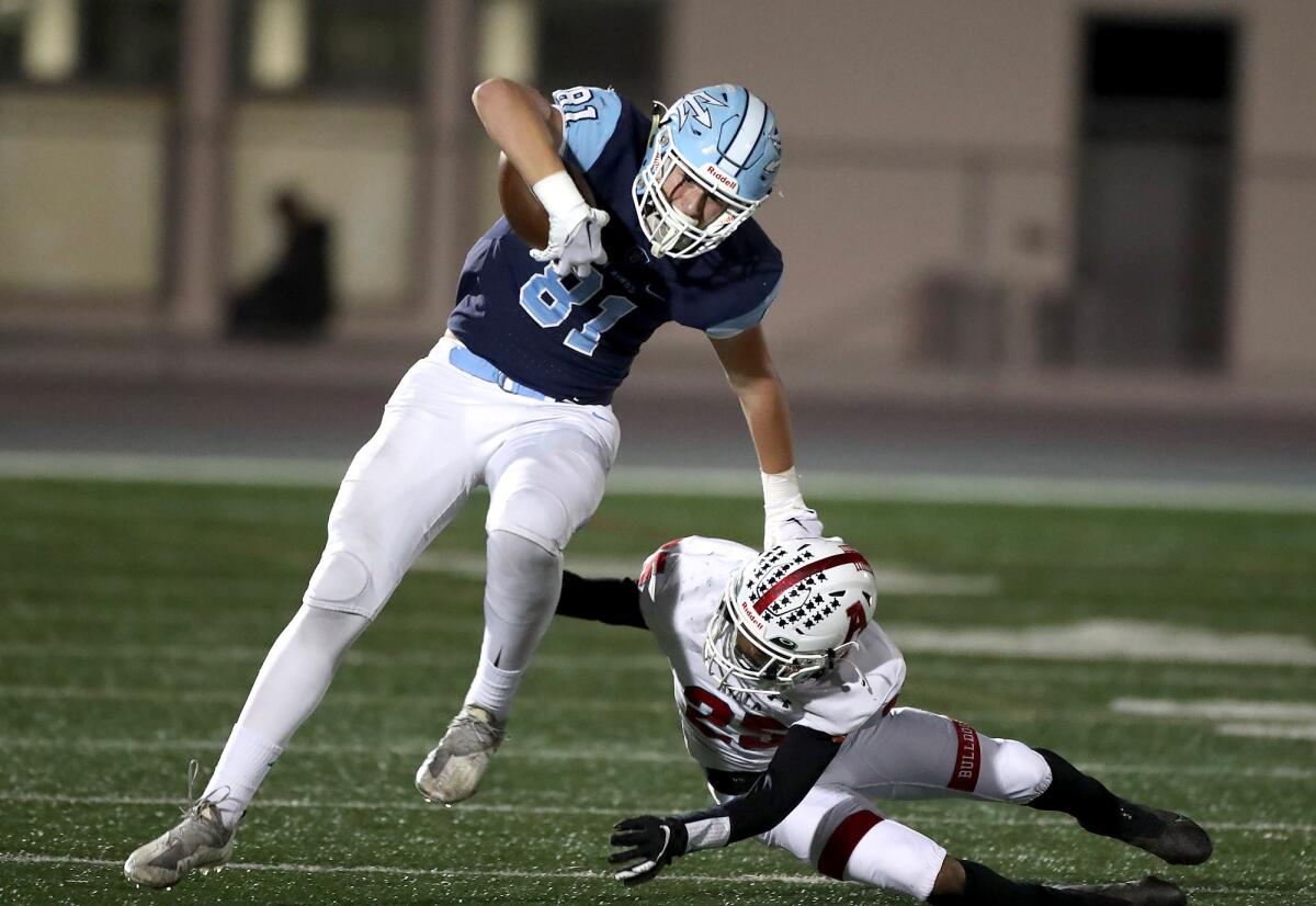 Corona del Mar's Zach Giuliano (81) side steps a tackle during a CIF Division 3 playoff opener against Ayala.