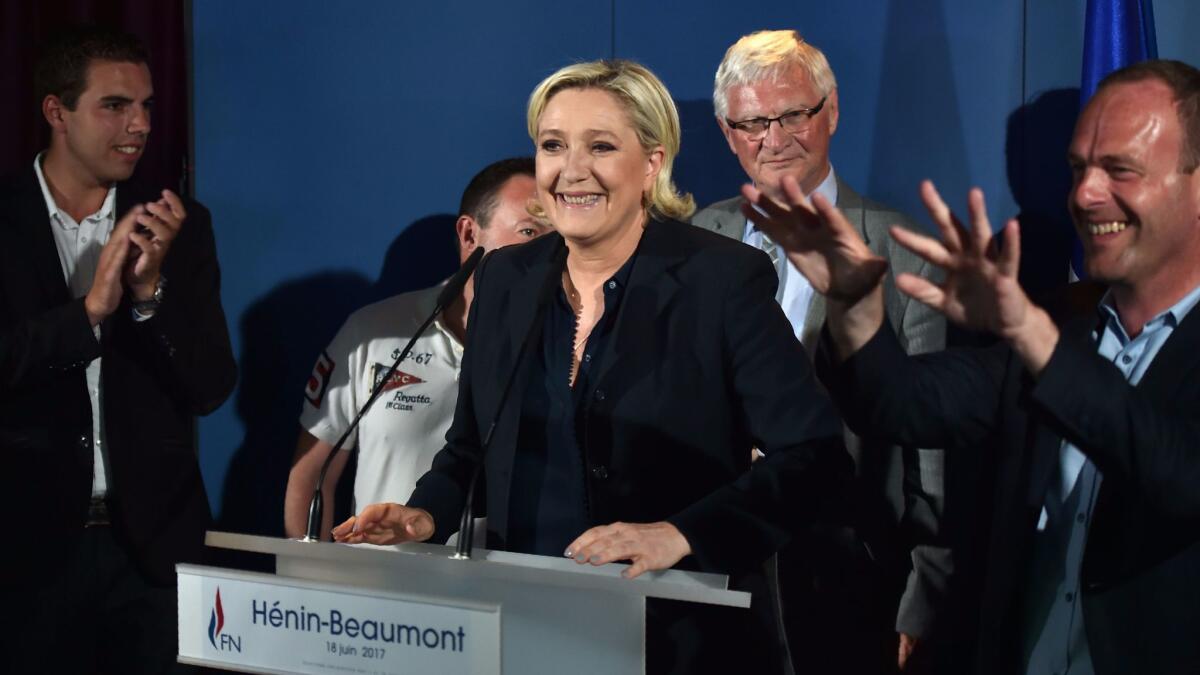 France's far-right National Front leader and parliamentary candidate Marine Le Pen, center, speaks in Henin-Beaumont, northern France, after the polls closed during the second round of the French parliamentary elections on June 18, 2017.