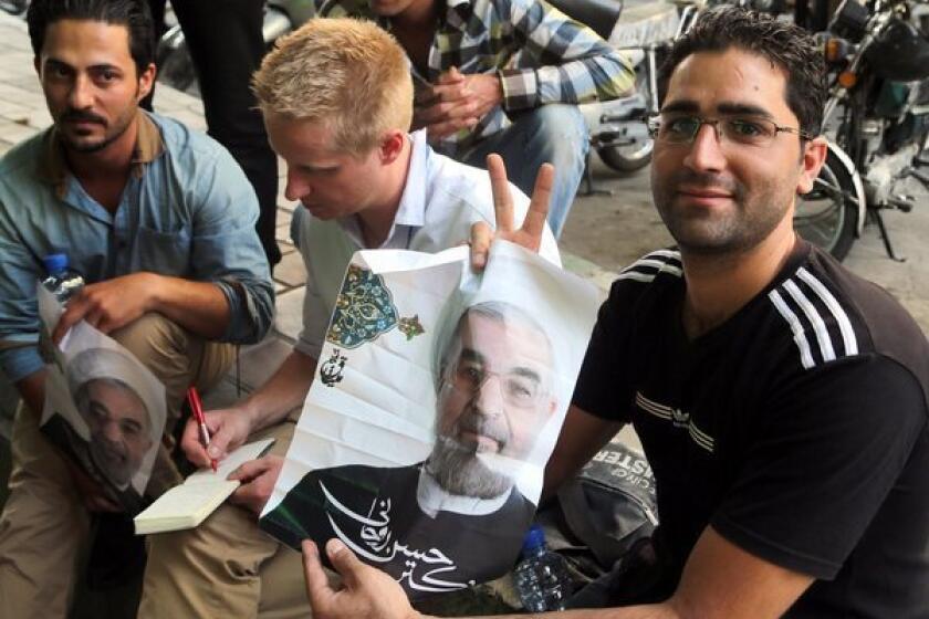 Supporters of Iranian presidential candidate Hassan Rowhani near his campaign office in Tehran, Iran.