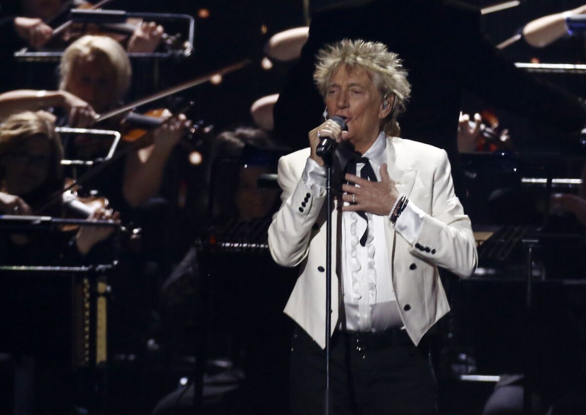 FILE - In this Feb. 18, 2020 file photo, Rod Stewart performs on stage at the Brit Awards 2020 in London. A Florida judge on Thursday, Sept. 9, 2021, has canceled the trial for Stewart and his adult son and scheduled a hearing next month to discuss a plea deal to resolve misdemeanor charges. The singer of 70s hits such as “Da Ya Think I’m Sexy?” and “Maggie May” and his son are accused of pushing and shoving a security guard at an upscale hotel because he wouldn’t let them into a New Year’s Eve party nearly two years ago. (Photo by Joel C Ryan/Invision/AP, File)