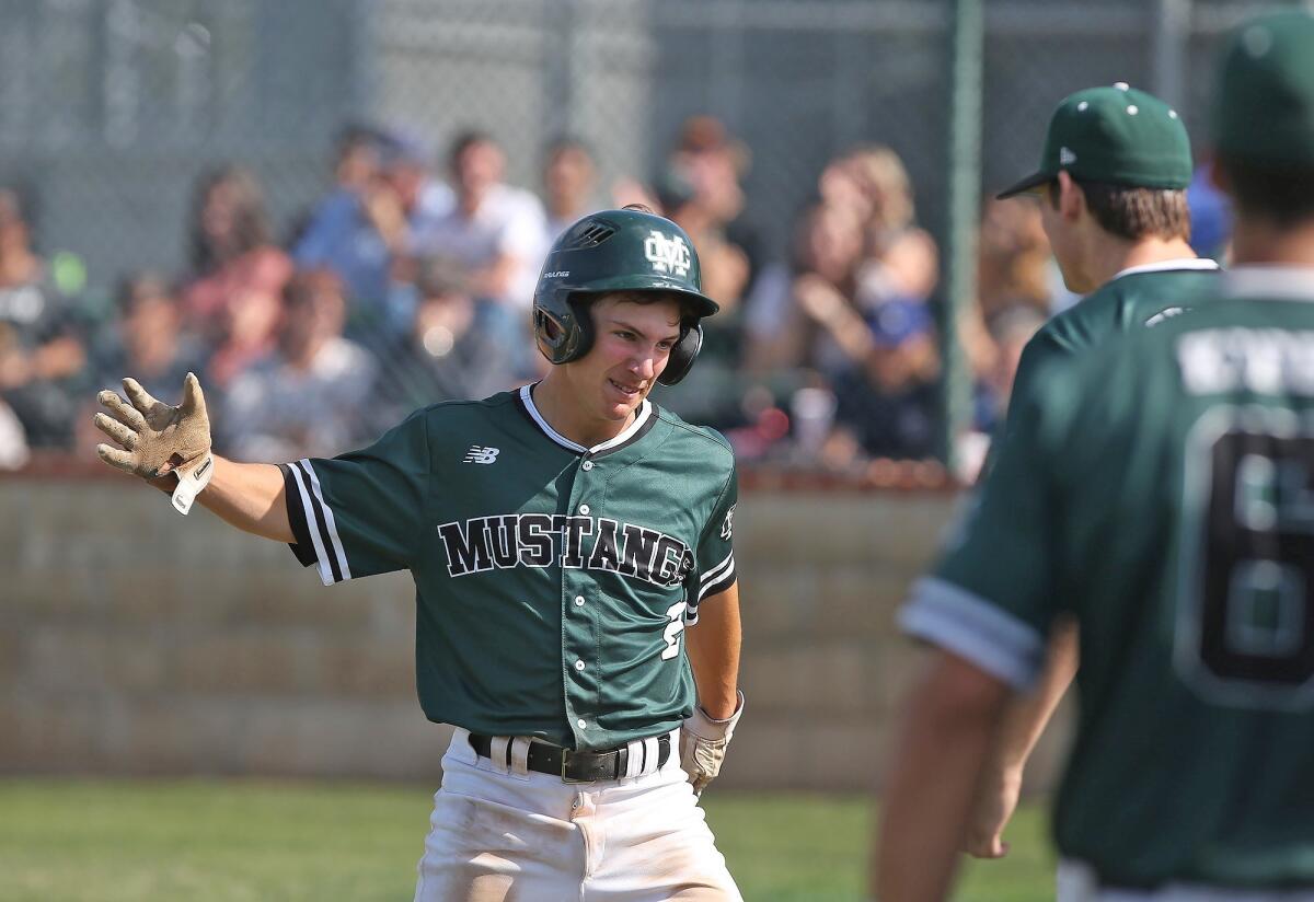 Costa Mesa High's Riley Mitchell celebrates a run scored during the semifinals of the CIF Southern Section Division 6 playoffs against Calvary Murrieta at home on Tuesday.