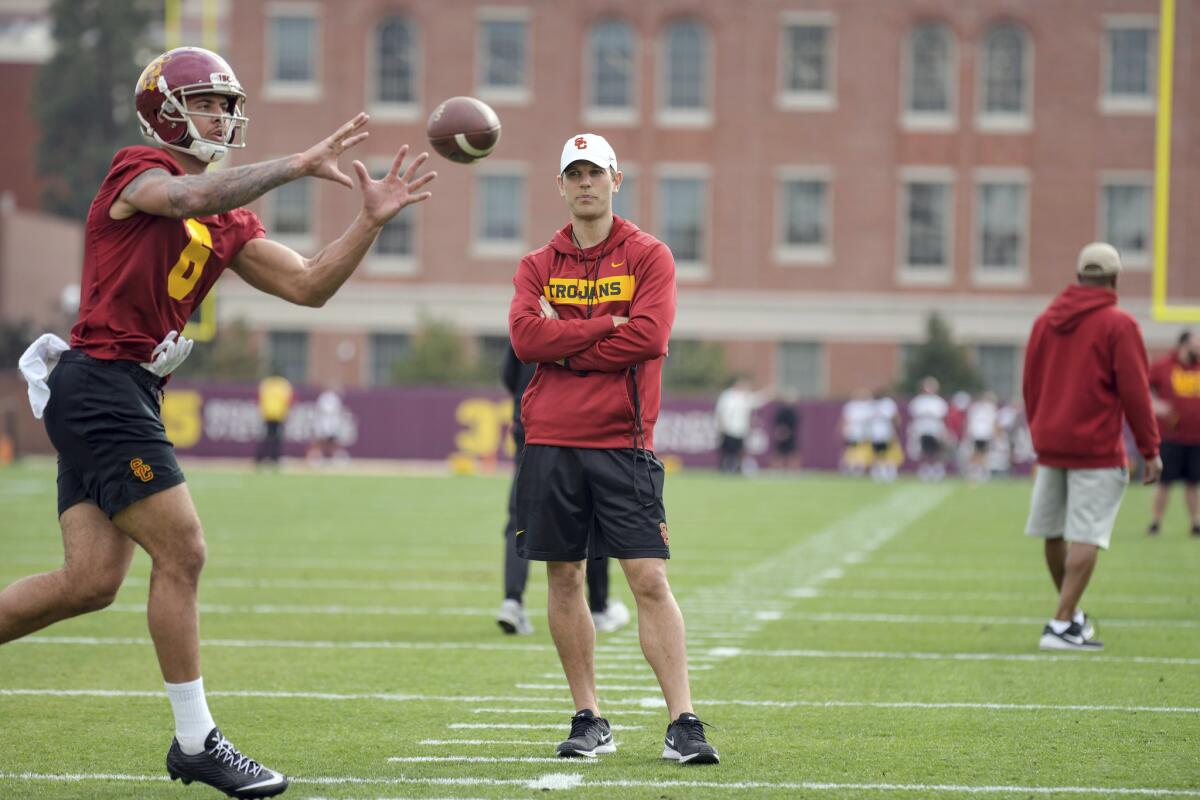 USC offensive coordinator Graham Harrell watches Michael Pittman during USC football practice.