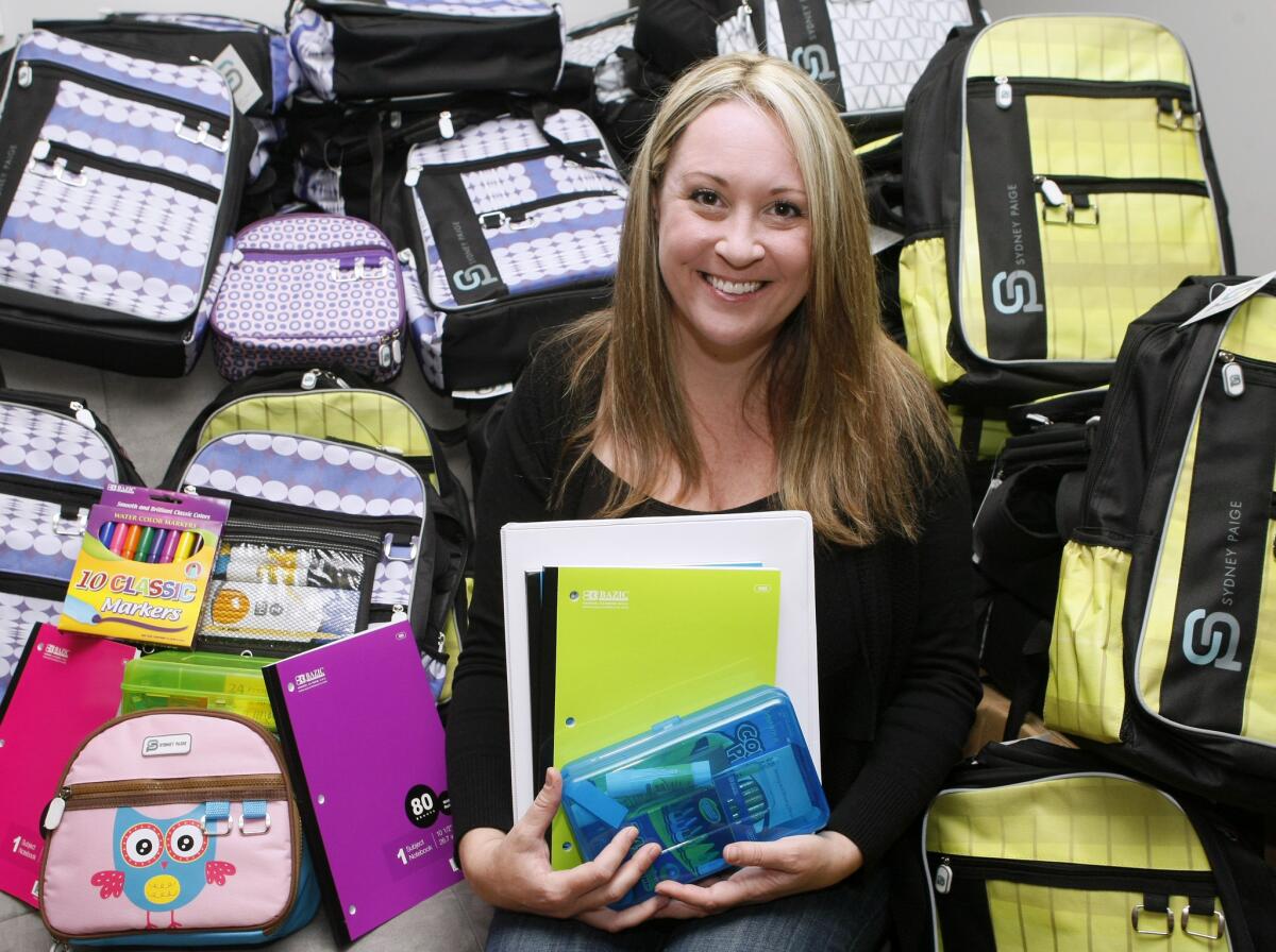 Sidney Page Inc. founder and CEO Courtney Brockmeyer shows off student backpacks she sells online from her home in La Canada Flintridge, on Friday, January 3, 2014. Brockmeyer launched her company last month and for every backpack bought, she donates a similar one, with additional school supplies included, to disadvantaged children.
