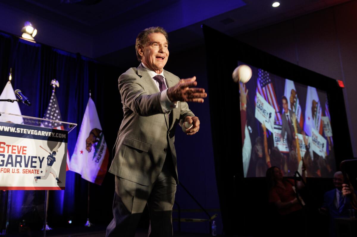 Steve Garvey tosses baseballs to supporters at his election night party in Palm Desert on March 5.
