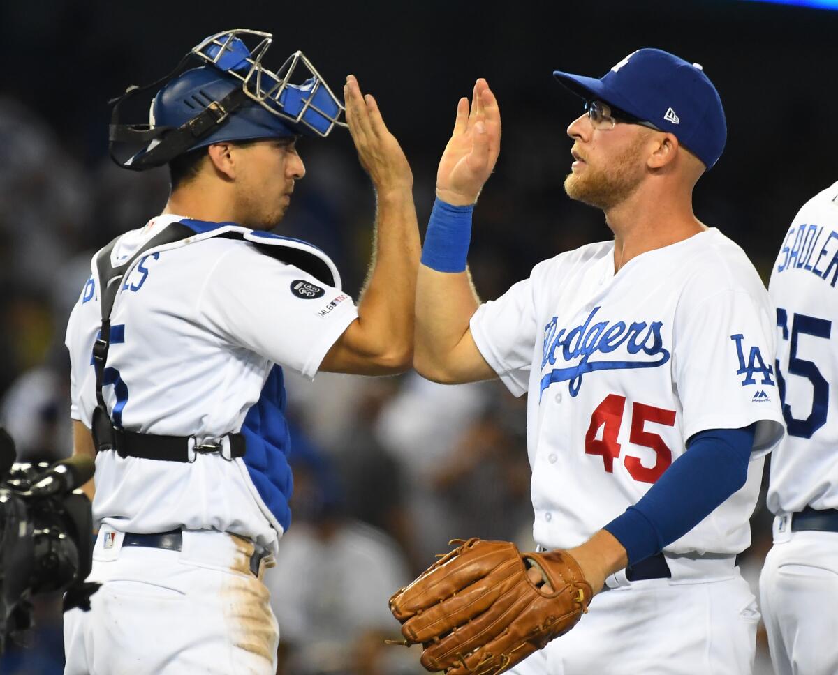 LOS ANGELES, CA - JULY 20: Matt Beaty #45 of the Los Angeles Dodgers is congratulated by Austin Barnes #15 of the Los Angeles Dodgers after the final out of the ninth inning of the game against the Miami Marlins at Dodger Stadium on July 20, 2019 in Los Angeles, California. (Photo by Jayne Kamin-Oncea/Getty Images) ** OUTS - ELSENT, FPG, CM - OUTS * NM, PH, VA if sourced by CT, LA or MoD **