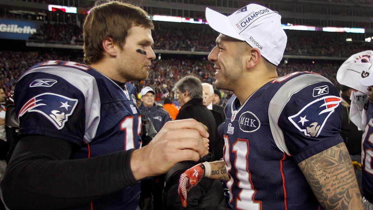 New England quarterback Tom Brady, left, congratulates Aaron Hernandez after the AFC championship game in January 2012, when the Patriots defeated the Baltimore Ravens.