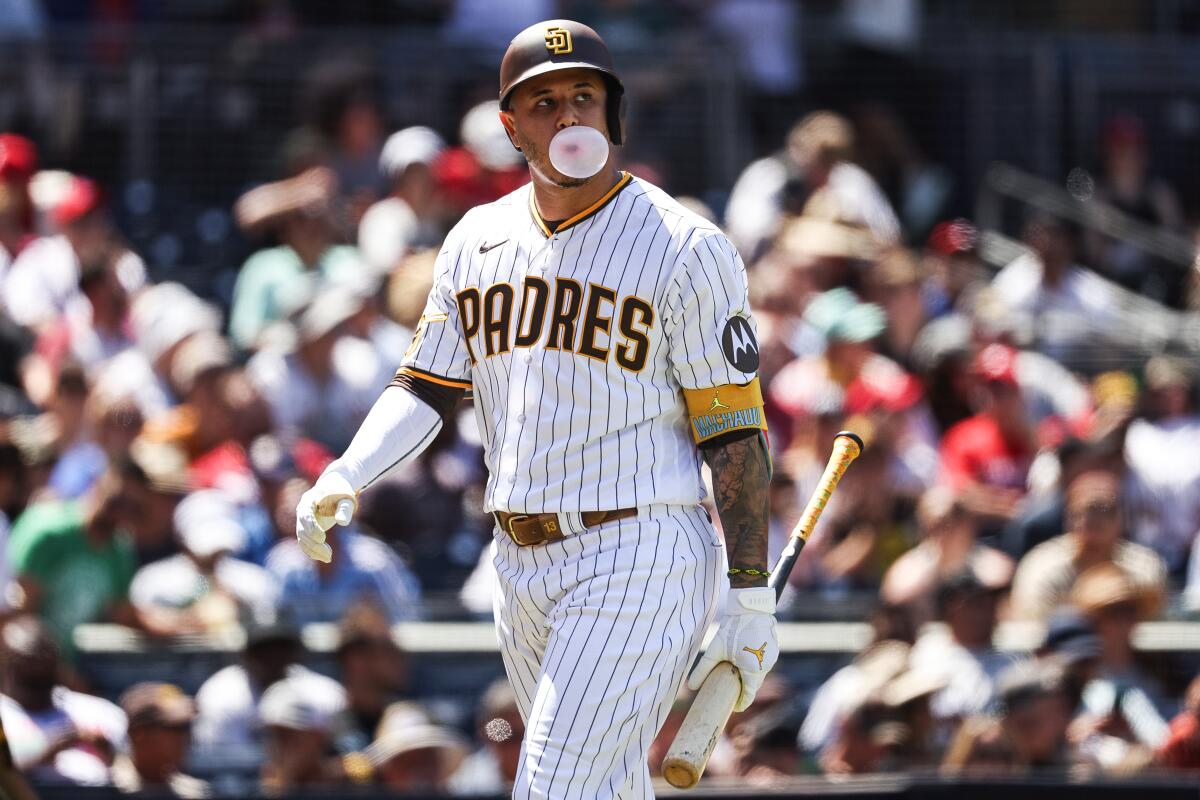 Padres designated hitter Manny Machado (13) blows a bubble after striking out.