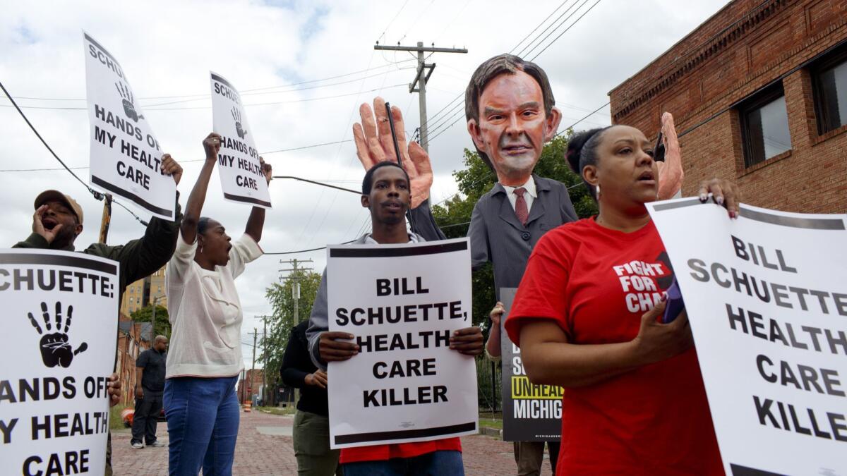 Service Employees International Union members protest at a campaign event for Michigan Atty. Gen. Bill Schuette in Detroit on Oct. 4. Schuette is running for governor against Democratic candidate Gretchen Whitmer.
