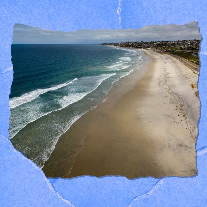 An aerial view of a stretch of empty sand and surf.