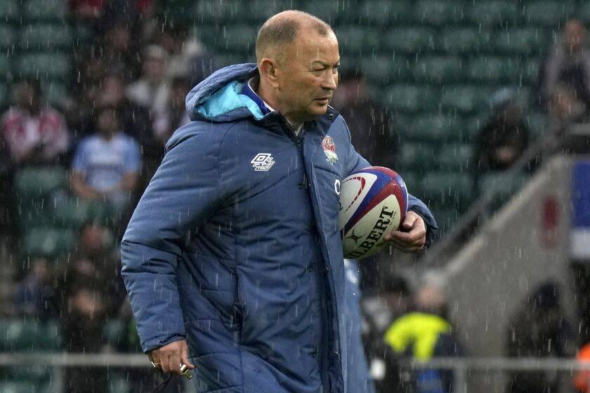 FILE - England's head coach Eddie Jones walks with a ball before the start of the rugby union international match between England and Argentina at Twickenham Stadium in London, Sunday, Nov. 6, 2022. Jones was fired on Tuesday, Dec. 6, 2022, less than a year out from the Rugby World Cup. Jones, who took charge after the 2015 World Cup, led England to the final of the tournament in 2019 and won three Six Nations titles in his seven years in charge. (AP Photo/Alastair Grant, File)
