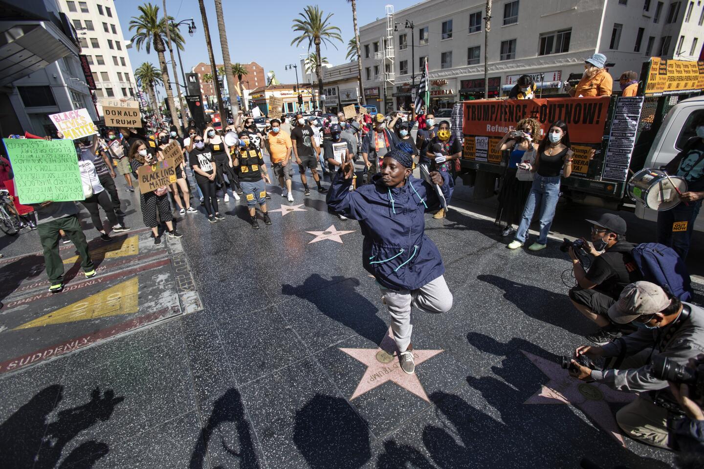 A protester dances on top of Donald Trump's star on the Hollywood Walk of Fame during a demonstration by members of Refuse Fascism